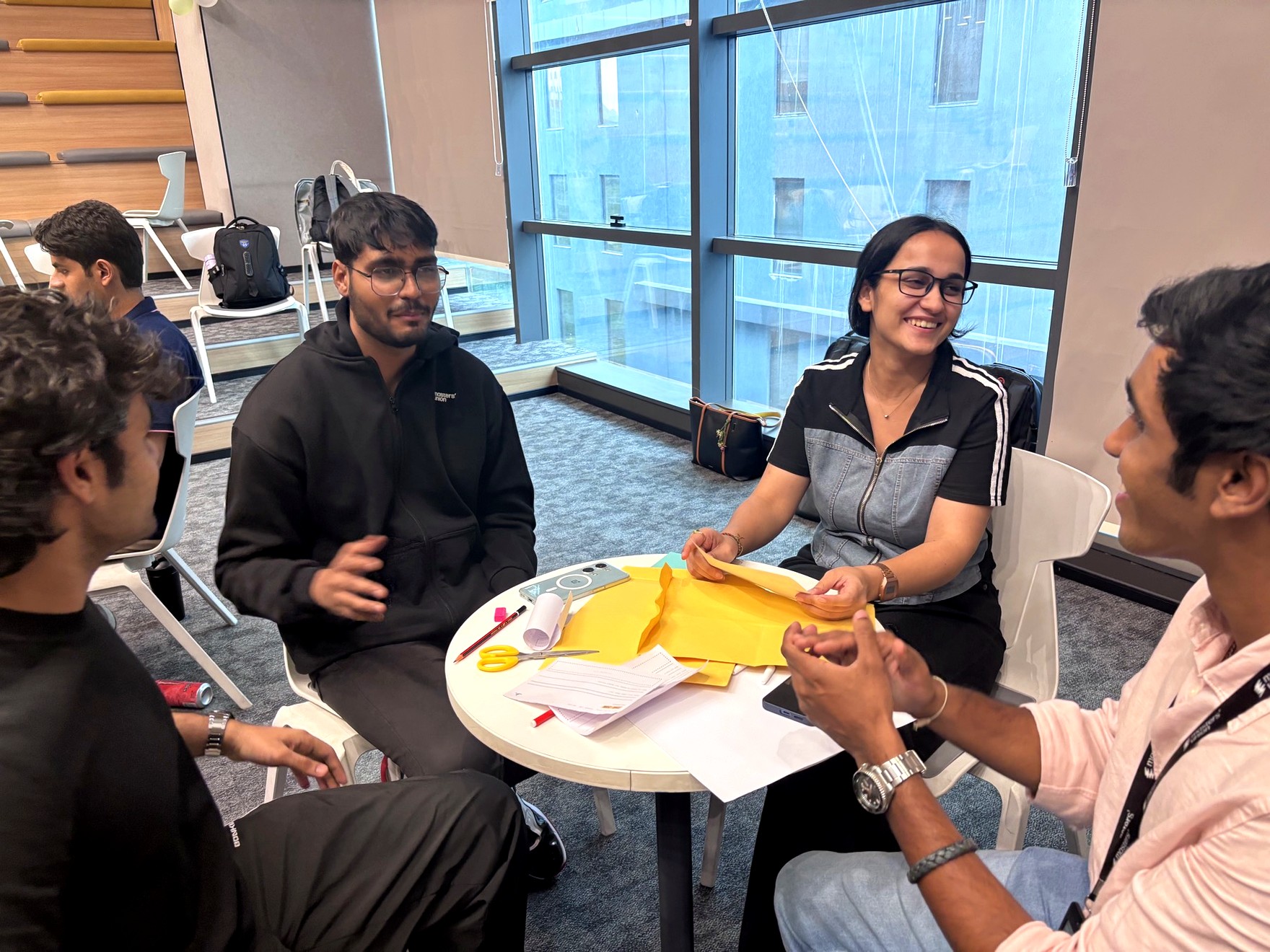 A team laughing while sketching their business on paper